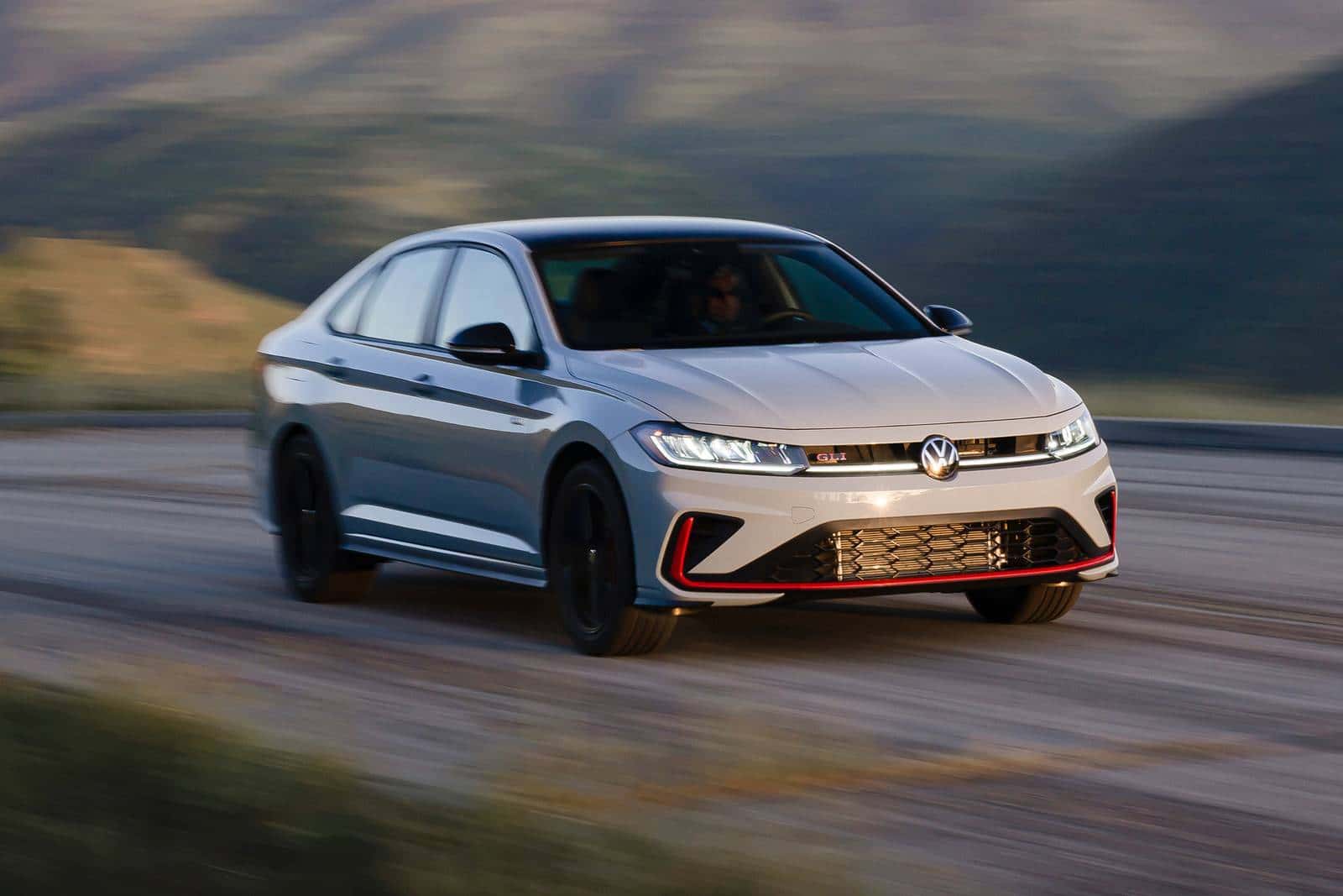The new 2026 Volkswagen Jetta GLI driving through the mountains