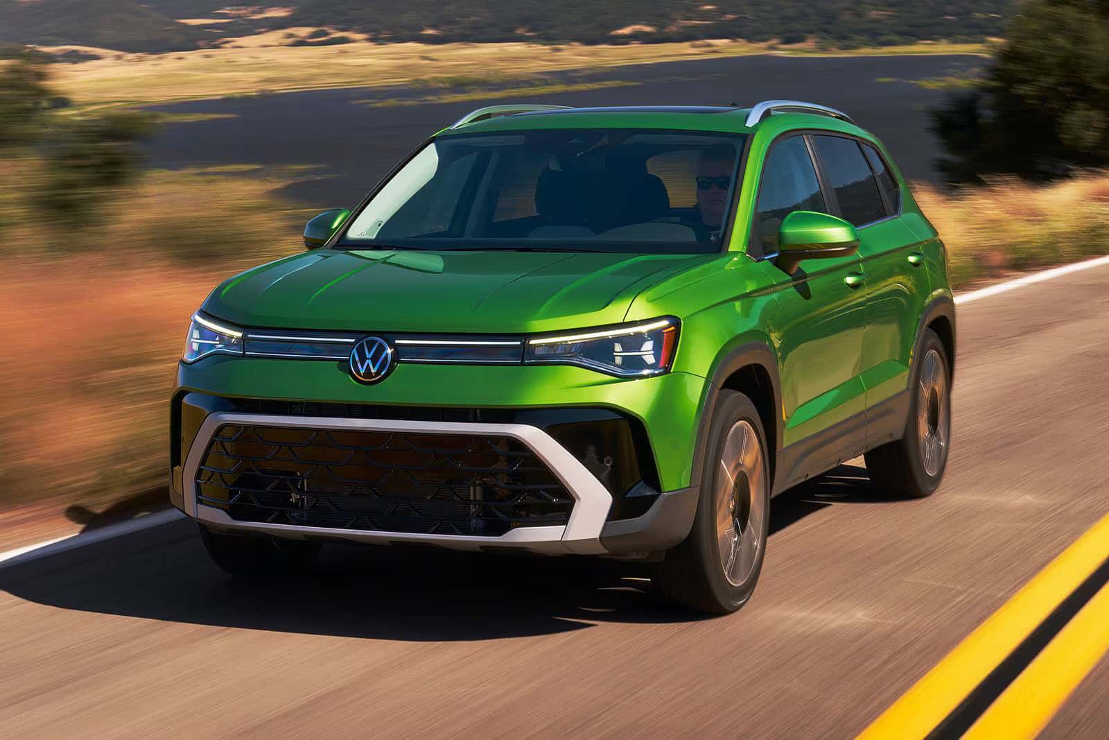 a new look at the Volkswagen Taos driving with a view of a body of water in the back ground