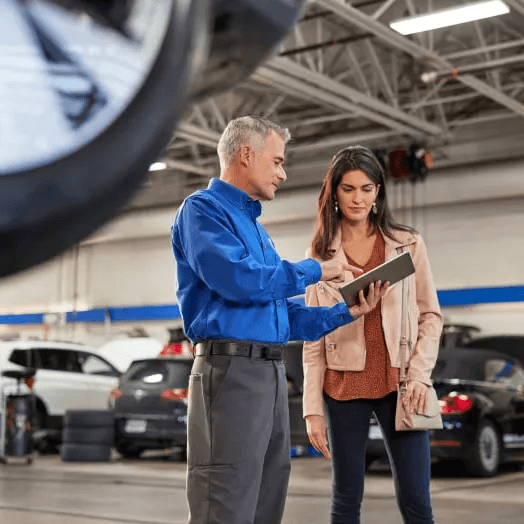 a Volkswagen service member helping a customer