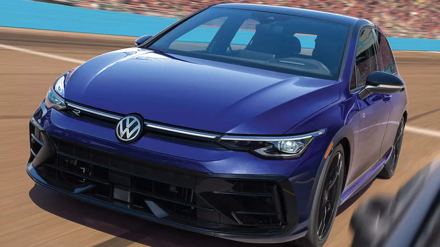 a view of a new 2026 golf gti driving on a road