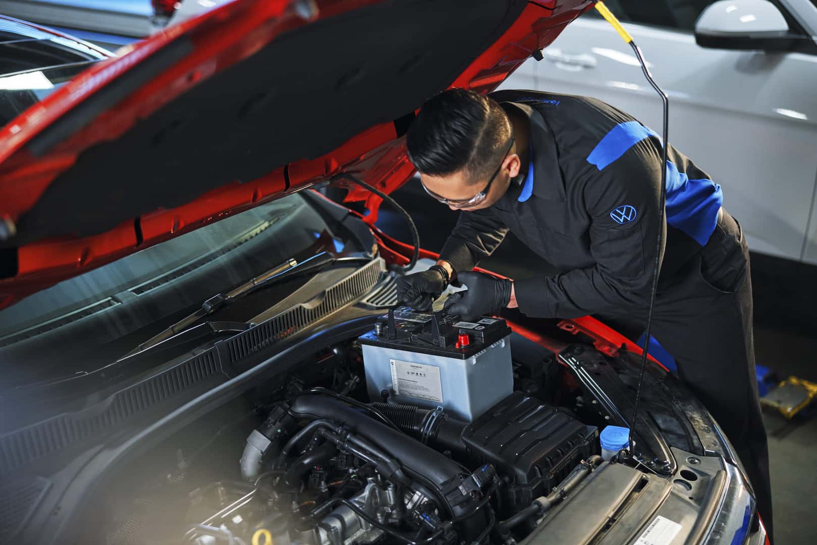 Volkswagen Technician Replacing Battery