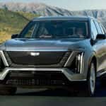 2026-Cadillac-VISTIQ-driving-on-a-highway-with-a-scenic-background