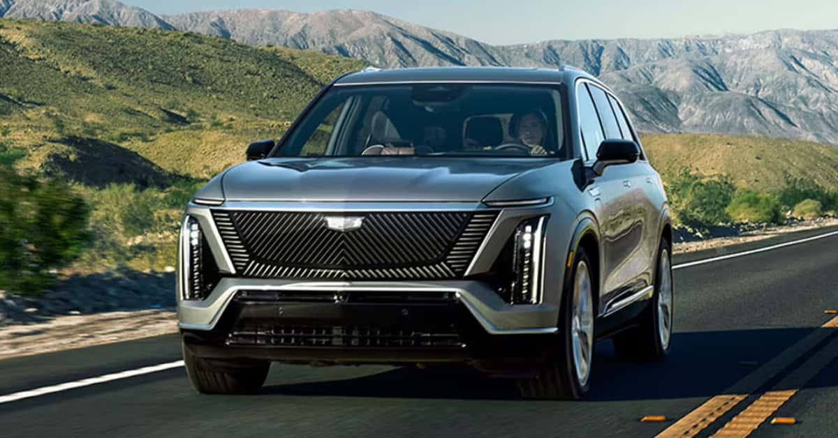 2026-Cadillac-VISTIQ-driving-on-a-highway-with-a-scenic-background