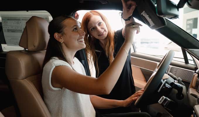 young woman talking to customer specialists at Walser Hyundai about great limited time offers in vehicle