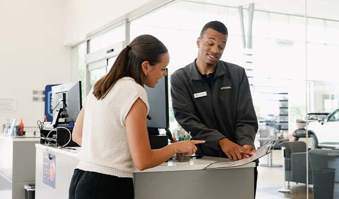 Young woman and service manager at Walser Hyundai discussing what is covered by walsercare at the dealership