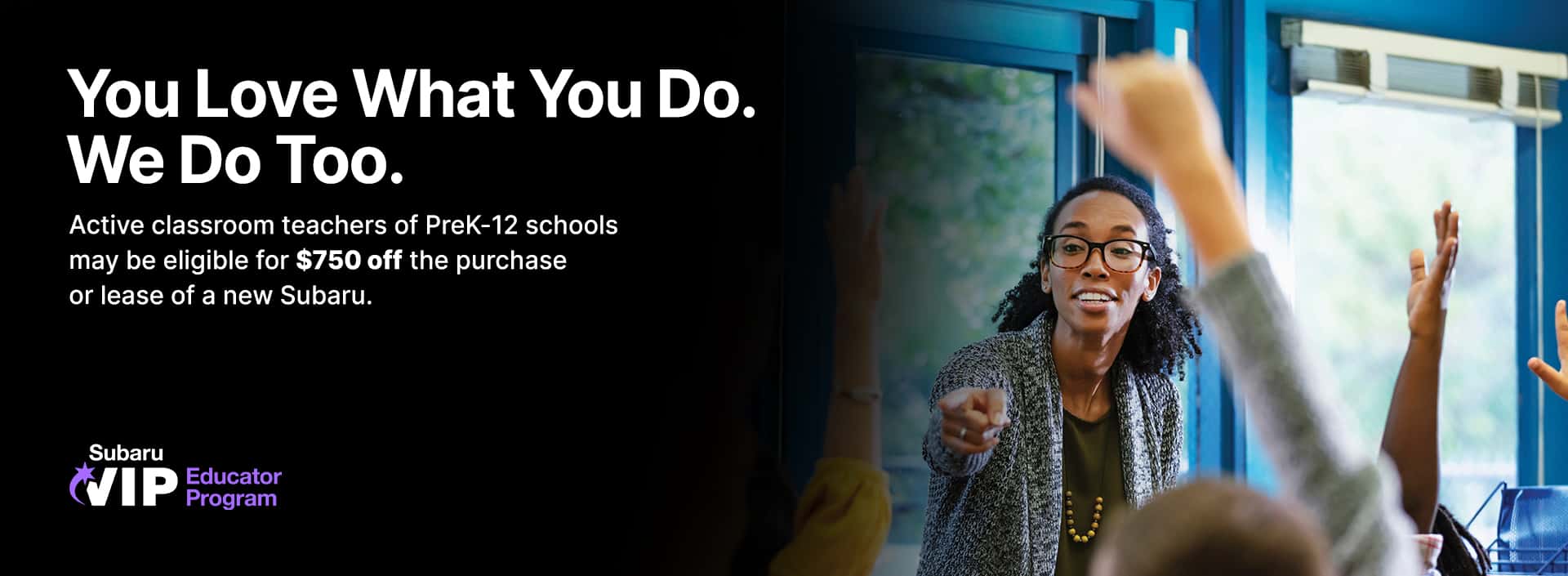 Teacher leading a classroom discussion with students raising their hands