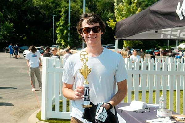 Guy at Subarus and Cold Brews Holding Cup of Cold Brew Coffee