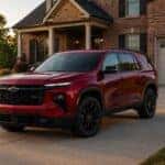 2026 Chevrolet Traverse in Radiant Red Tintcoat parked in suburban driveway at golden hour — Webb Chevy Oak Lawn serving Oak Lawn, Orland Park, and Chicago south suburbs, IL