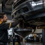 Chevrolet service technician performing oil change and inspection at Webb Chevy Oak Lawn in Oak Lawn, IL