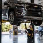 Certified GM technician performing summer service inspection at Webb Chevy Plainfield in Plainfield, IL