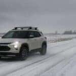 2027 Chevrolet Trailblazer driving on a snowy road at Webb Chevy Plainfield, Plainfield, IL
