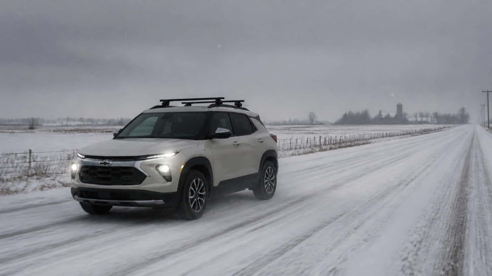 2027 Chevrolet Trailblazer driving on a snowy road at Webb Chevy Plainfield, Plainfield, IL