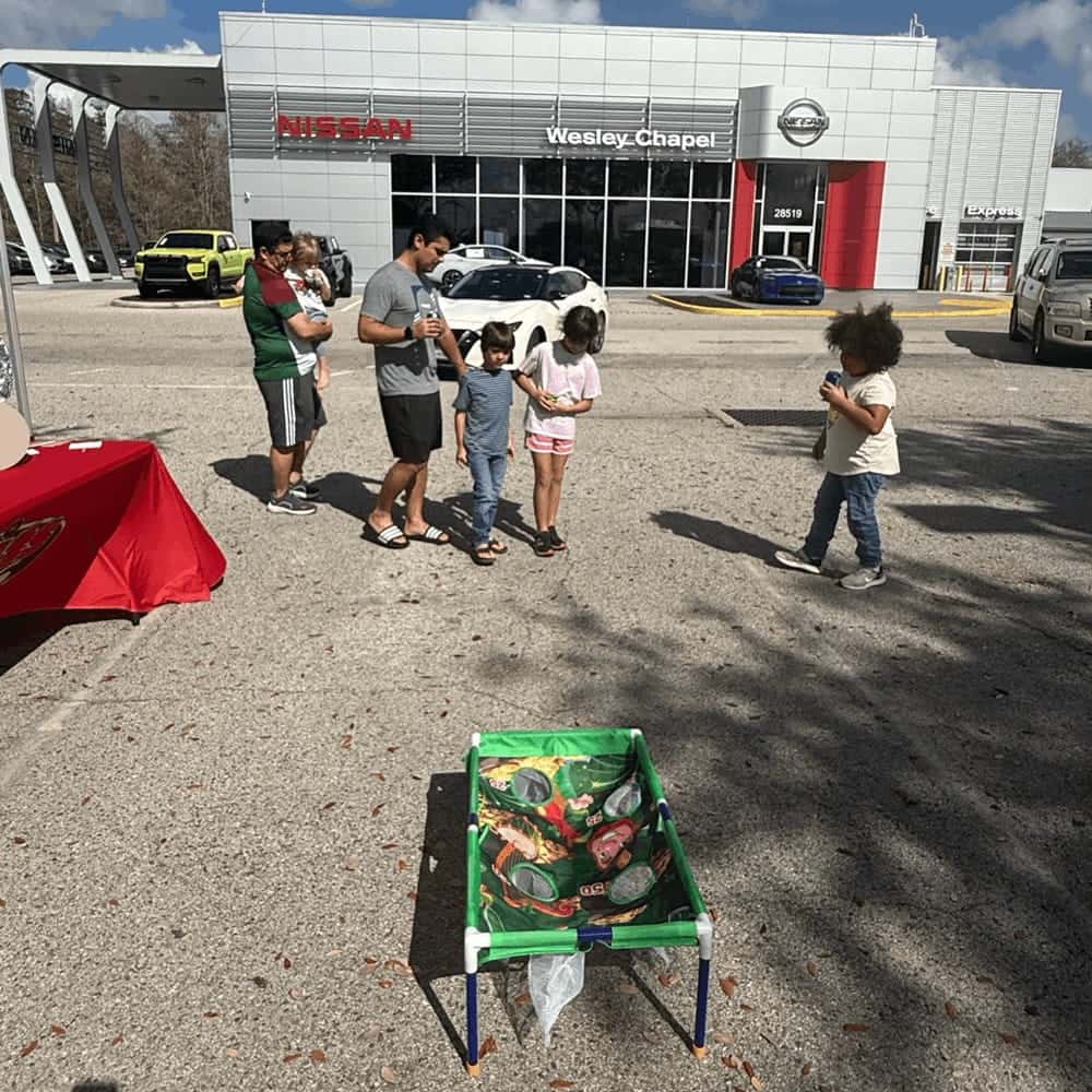Family Playing Corn Hole at Event