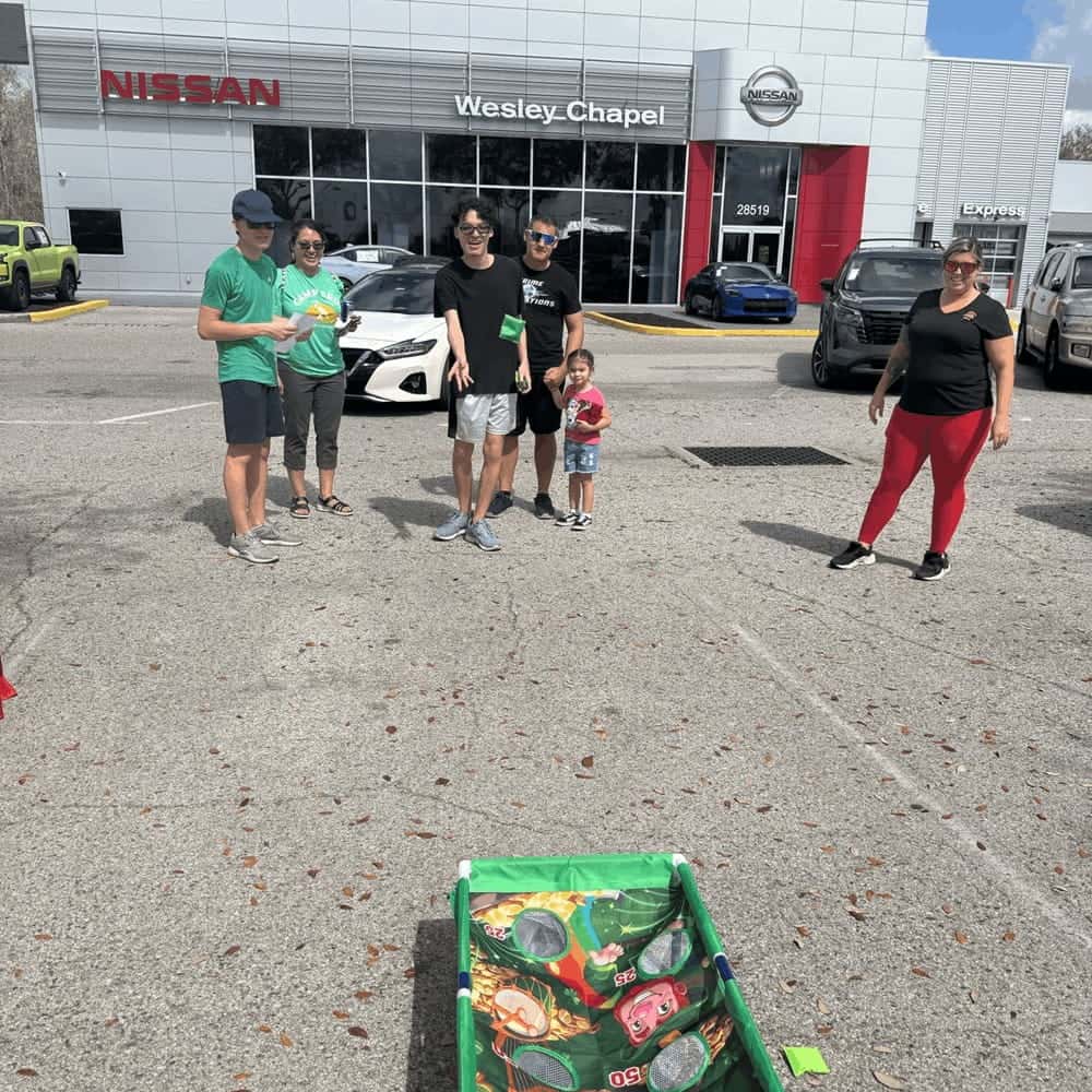 Second Family Playing Corn Hole at Event
