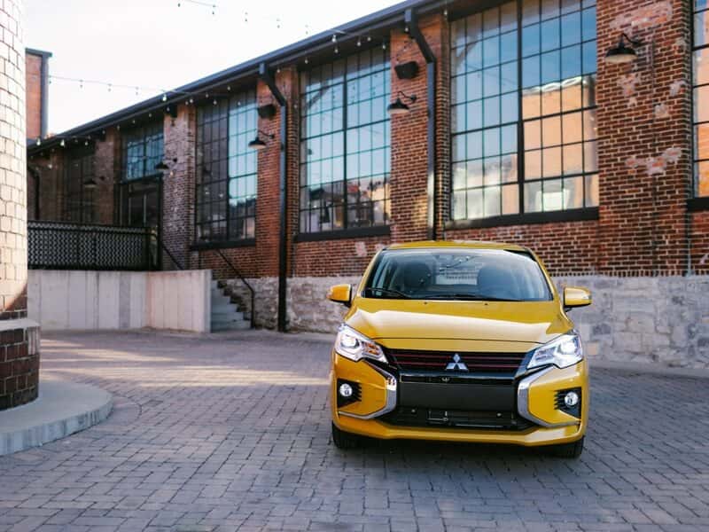 Front view of Mitsubishi Mirage parked next to building from Mitsubishi Dealer near Me