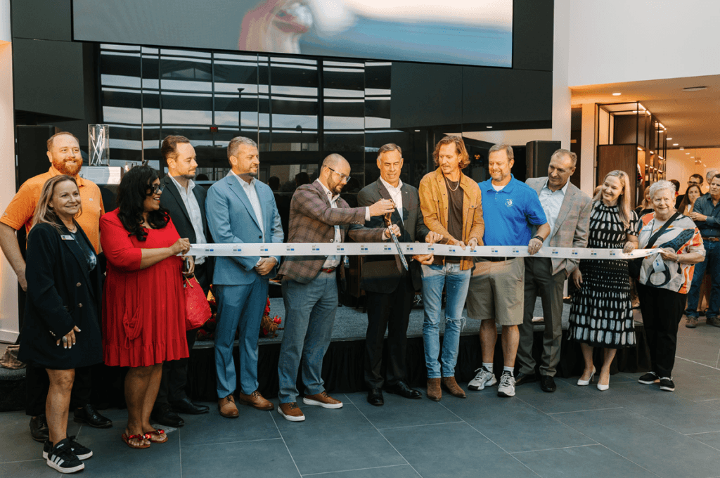General Sales Manager Ryan Pemberton leads the ribbon cutting at the Porsche Des Moines Grand Opening
