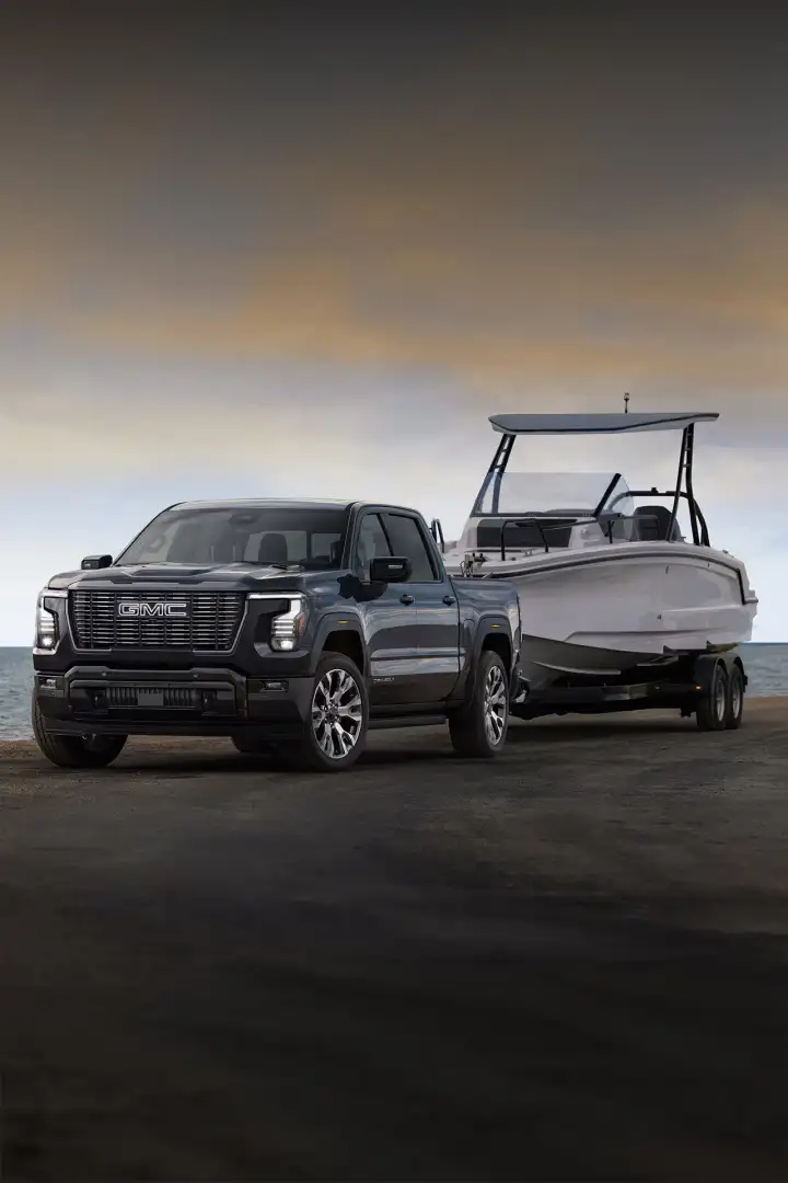 2027 GMC Sierra 1500 Denali Ultimate towing a boat