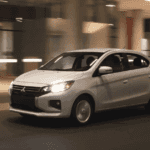 2024 Mitsubishi Mirage G4 exterior driving at night showing illuminated headlights and compact sedan profile