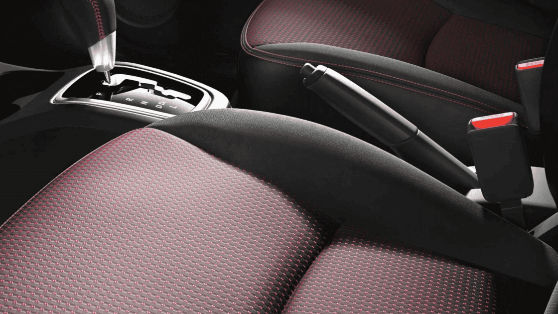 2024 Mitsubishi Mirage G4 cloth seat close up with red stitching, automatic gear selector, and hand brake