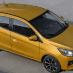 2024 Mitsubishi Mirage yellow hatchback photographed from elevated angle on concrete surface