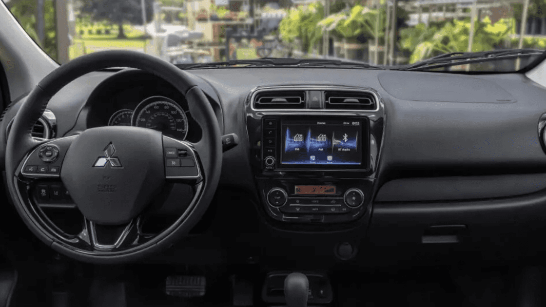 2024 Mitsubishi Mirage interior dashboard with touchscreen infotainment, steering wheel controls, and automatic transmission center console