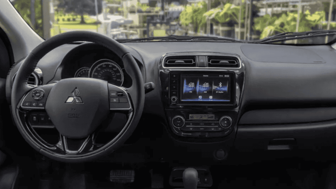 2024 Mitsubishi Mirage dashboard interior with touchscreen infotainment, steering wheel controls, and compact cabin layout