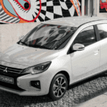 2024 Mitsubishi Mirage front three quarter exterior in white parked on cobblestone street with alloy wheels