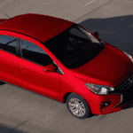 2024 Mitsubishi Mirage G4 red sedan shown from overhead angle driving on paved road