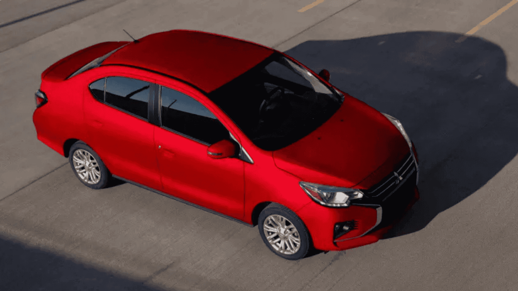 2024 Mitsubishi Mirage G4 red sedan shown from overhead angle driving on paved road