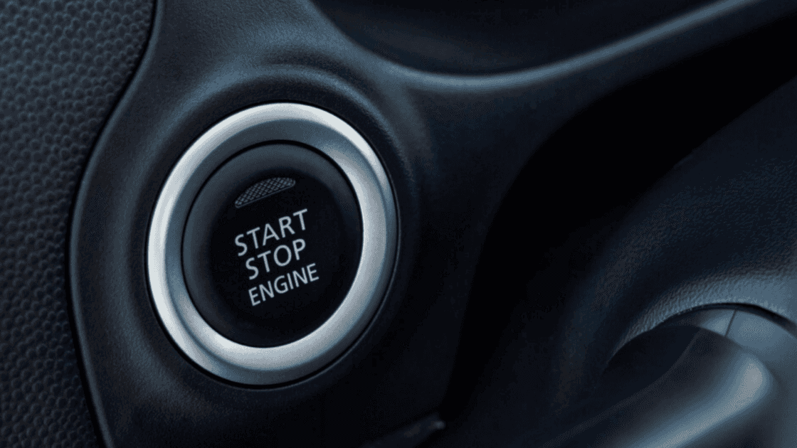 Close-up shot of the engine start/stop button in a Mitsubishi vehicle.