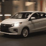 2024 Mitsubishi Mirage G4 exterior driving at night with headlights on highlighting compact sedan profile