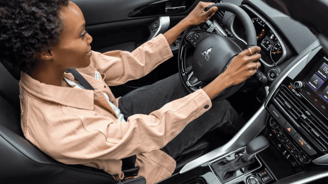 2025 Mitsubishi Eclipse Cross driver cockpit showing steering wheel controls, touchscreen infotainment, and automatic center console