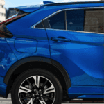 2025 Mitsubishi Eclipse Cross rear side exterior in blue highlighting sculpted body lines, alloy wheels, and rear quarter design