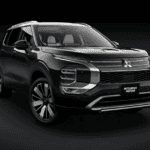 2025 Mitsubishi Outlander Sport front three quarter exterior in black studio setting showing grille design, alloy wheels, and bold styling