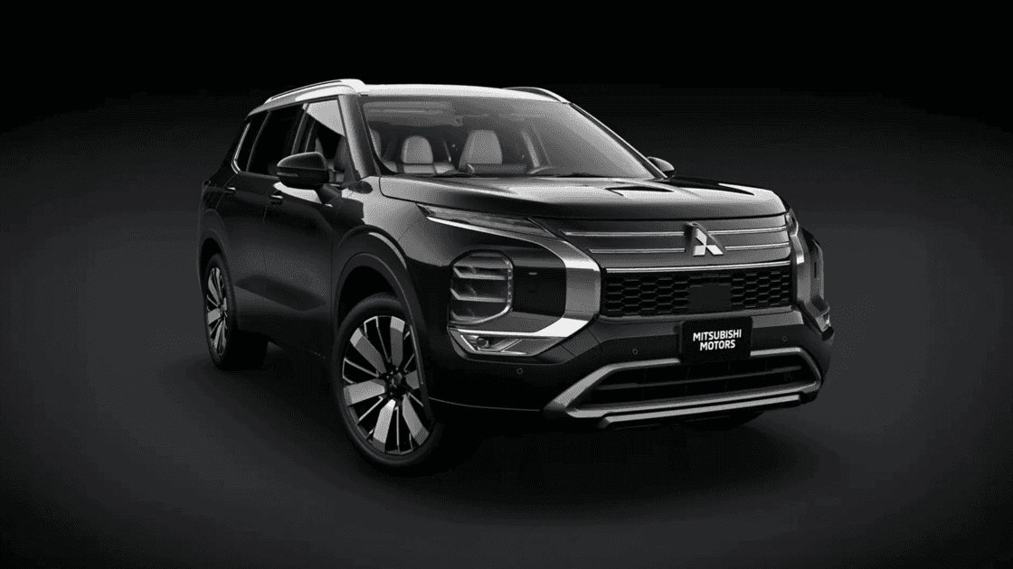 2025 Mitsubishi Outlander Sport front three quarter exterior in black studio setting showing grille design, alloy wheels, and bold styling