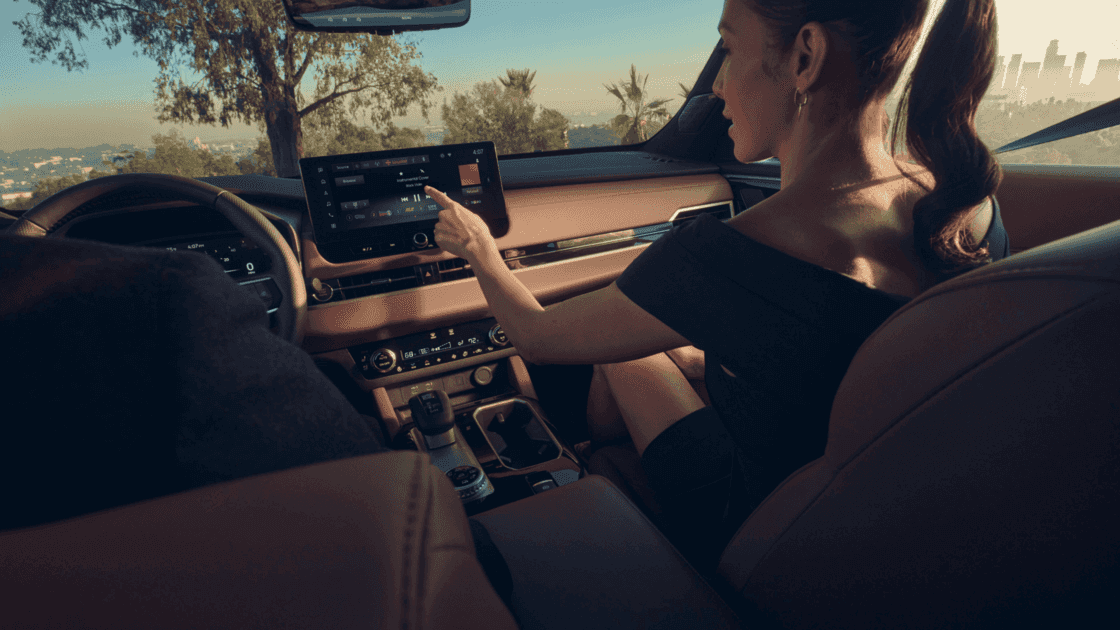 2025 Mitsubishi Outlander front passenger interior showing touchscreen infotainment, center console controls, and premium seating