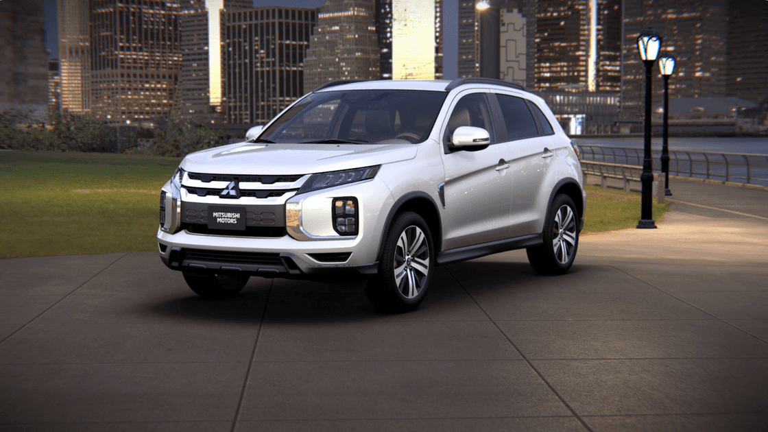 2025 Mitsubishi Outlander Sport silver exterior front three-quarter night city view