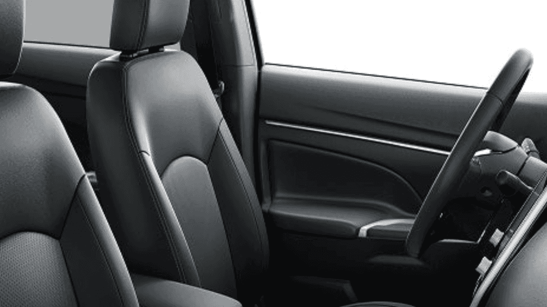 2025 Mitsubishi Outlander Sport interior front seats showing driver position, steering wheel, and modern door panel design