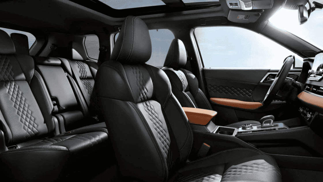 2025 Mitsubishi Outlander PHEV interior with quilted leather seats, panoramic roof, center console, and second row seating