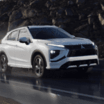 2026 Mitsubishi Eclipse Cross front three-quarter view driving on wet road in white