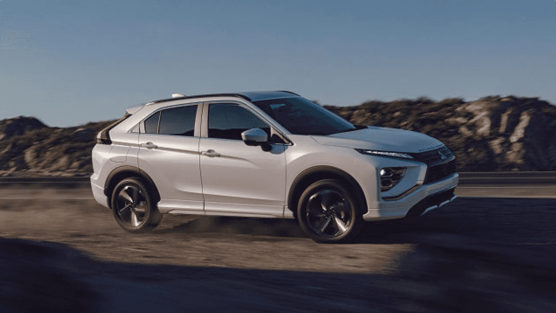2026 Mitsubishi Eclipse Cross white exterior side profile driving on highway