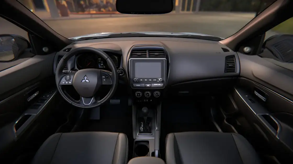 2026 Mitsubishi Outlander Sport interior cockpit with touchscreen infotainment, multifunction steering wheel, and clean dashboard layout