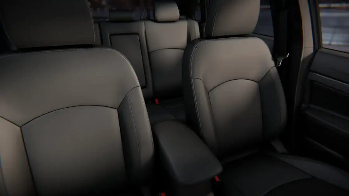2026 Mitsubishi Outlander Sport interior seating with black cloth seats, front armrest, and comfortable compact SUV cabin design
