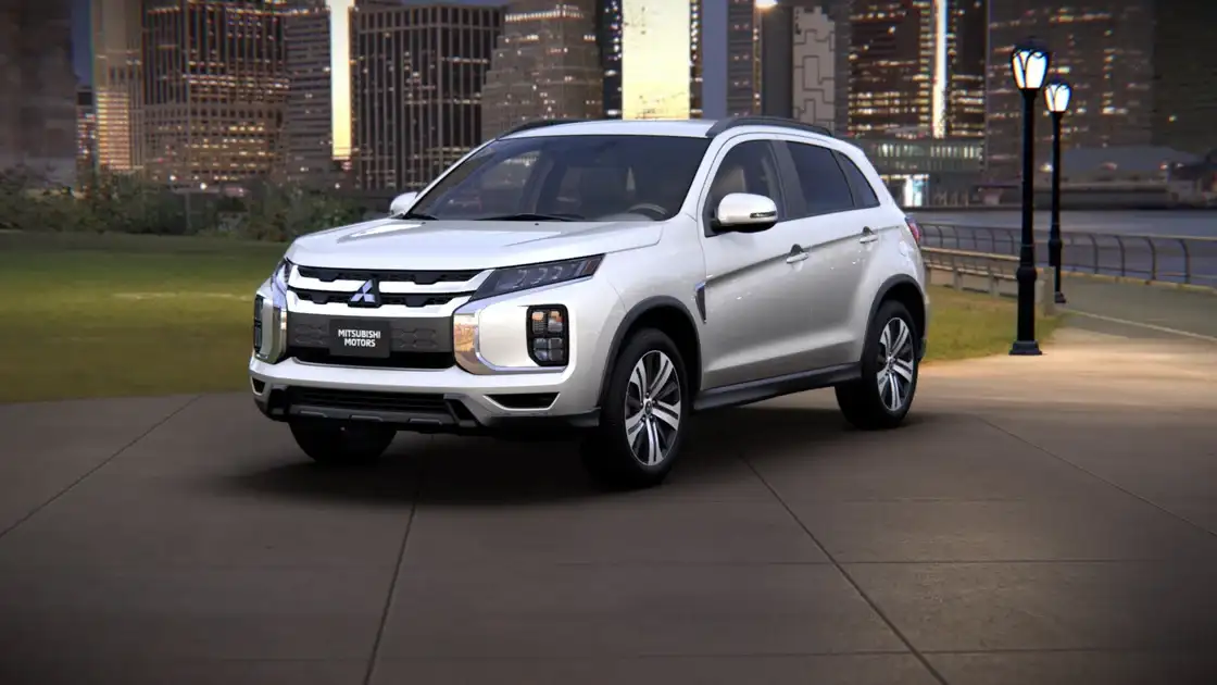 2026 Mitsubishi Outlander Sport front three quarter exterior in white showing LED lighting, signature grille, and compact SUV profile