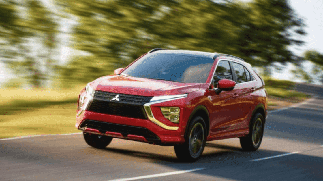 Front exterior view of red 2026 Mitsubishi Eclipse Cross driving on a road
