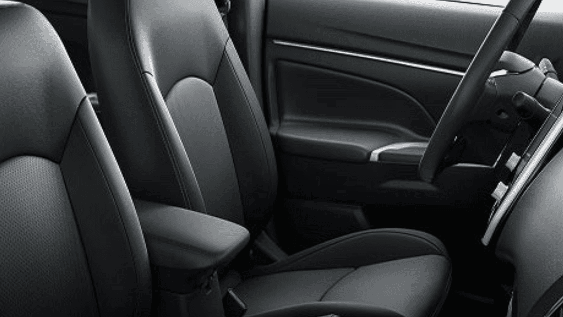 Interior view of front seats in 2026 Mitsubishi Outlander Sport with black upholstery