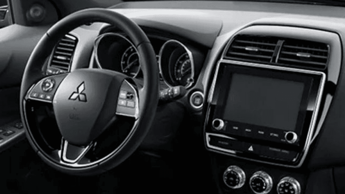Interior view showing steering wheel and dashboard of 2026 Mitsubishi Outlander Sport