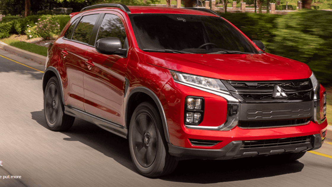 2026 Mitsubishi Outlander Sport red SUV driving on road with black grille and roof rails