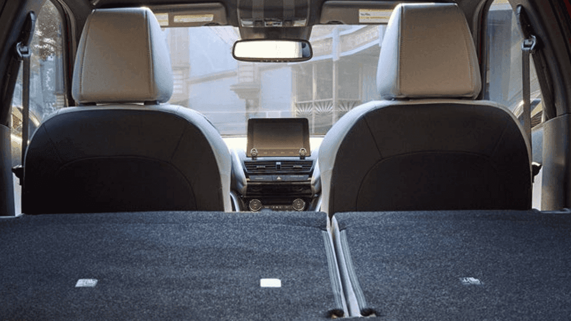 2026 Mitsubishi Eclipse Cross cargo area with folded rear seats and front cabin view