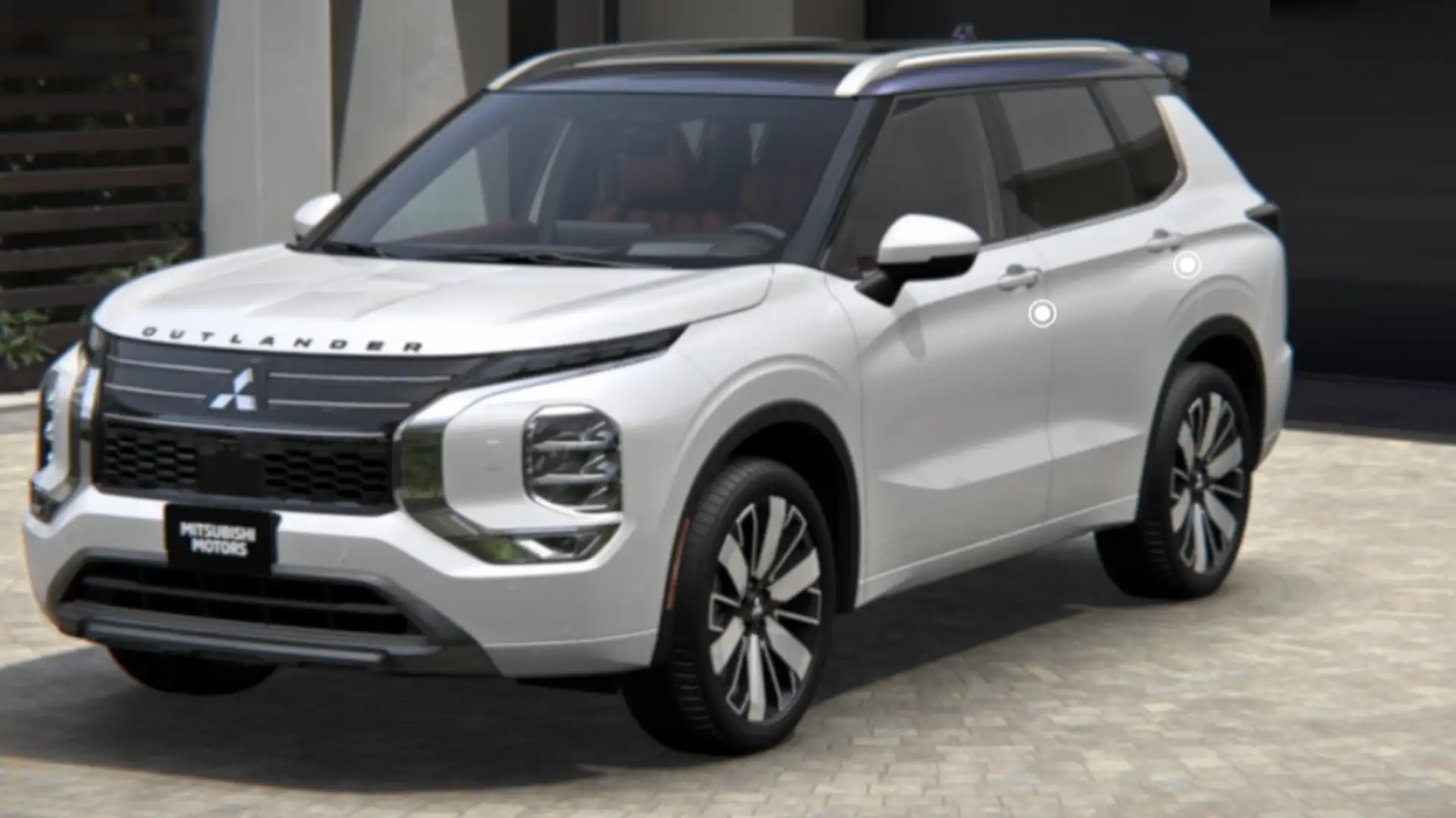 2026 Mitsubishi Outlander white SUV parked outside a modern home with roof rails and alloy wheels